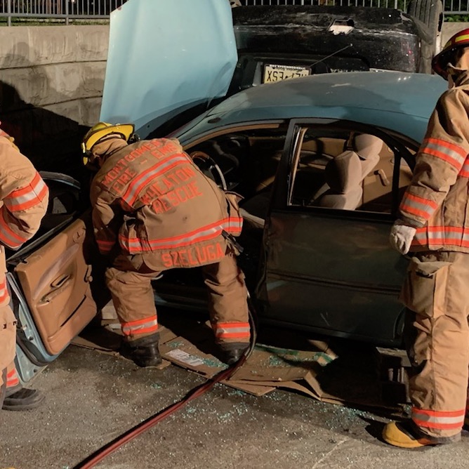 Firefighters cutting vehicle